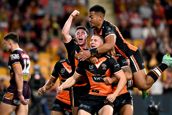 Tigers playmaker Adam Doueihi, who carved up the Broncos last season, is seen here celebrating scoring a try at Suncorp.