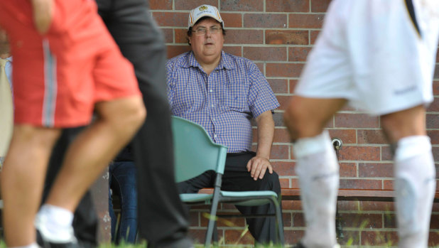 Clive Palmer watches Gold Coast United FC players train in 2009.