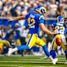 Ethan Evans shapes for a drop punt-style kick as the Los Angeles Rams take on the New Orleans Saints.