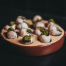 The French menu includes escargot.