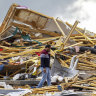 Gopala Penmetsa walks past his house after it was leveled by a tornado near Omaha, Neb., USA.