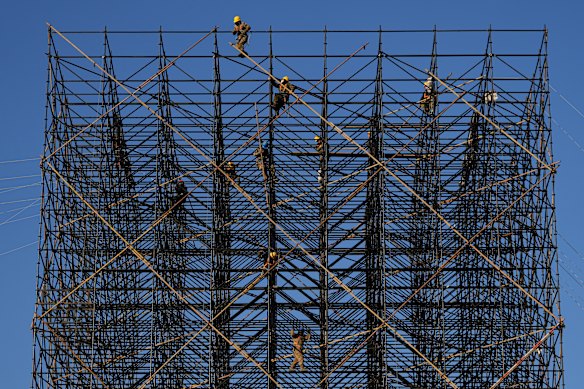 Workers prepare scaffolding ahead of a new year countdown event to be held in Beijing.