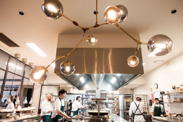 The huge kitchen is equipped with a custom-made wood-fired grill and a 12-seat chef’s table behind glass.   