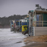 Beach boxes exposed to the sea at Mount Martha North 