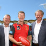 Damien Hardwick with Gold Coast chief executive Mark Evans and chairman Bob East.