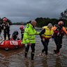 Robyn Doust and her dog Gypsy being rescued by NSW Fire & Rescue strike team alpha and bravo members and SES on the Manning River Drive near Taree in Purfleet, NSW. May 21, 2025.  Photo: Kate Geraghty 