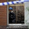 A NSW Police forensic officer inside a burnt room of the Croydon house.