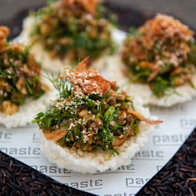 Roast duck, curry paste and coriander on rice crackers. 