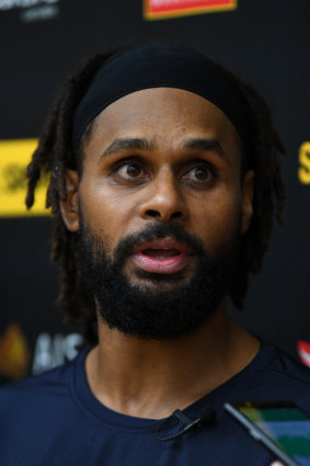 Patty Mills addressing the media in Melbourne.