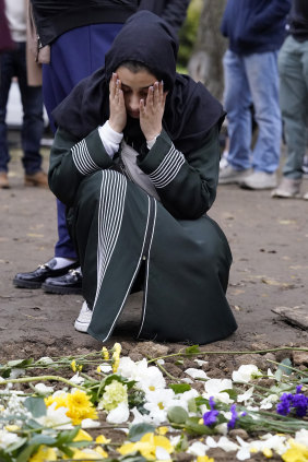 A mourner at the grave of Wadea Al Fayoume on Monday.