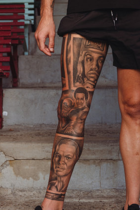 Close up of Harry Garside’s leg, which features tattooed portraits of his favourite boxers.