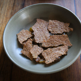 Cured kingfish with lemonade fruit, oats and isot chili.