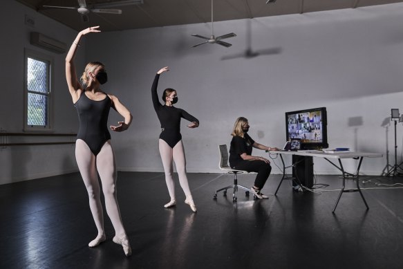 Ballet teacher Mel Coady runs an online class while her daughters Ella, 15, and Indi, 19, dance along at their studio in Hurlstone Park.  