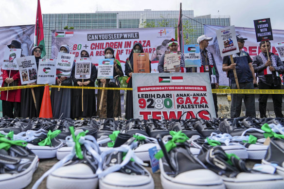 Protesters display posters and children’s shoes to represent children killed in the war between Israel and Hamas in Gaza, during a rally outside the US embassy in Jakarta, Indonesia, on Monday.