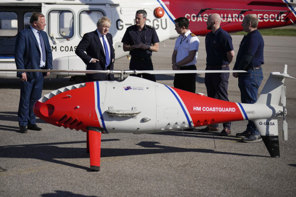 British PM Boris Johnson views a Coastguard drone used for surveillance and rescue of migrants at Lydd Airport in Dover on Thursday.