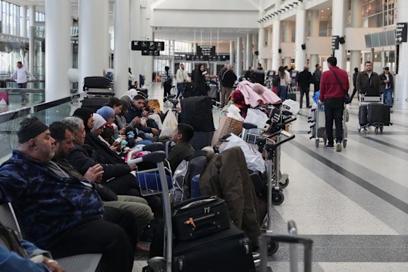 Passengers whose flights were cancelled, wait at the departure terminal of Rafik Hariri International Airport in Beirut.