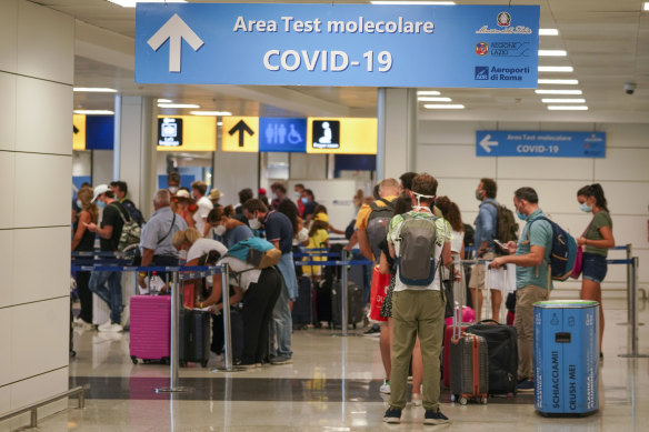 Travellers arrive at Rome's Leonardo da Vinci airport to be tested for the coronavirus as per a new rule imposed last week.