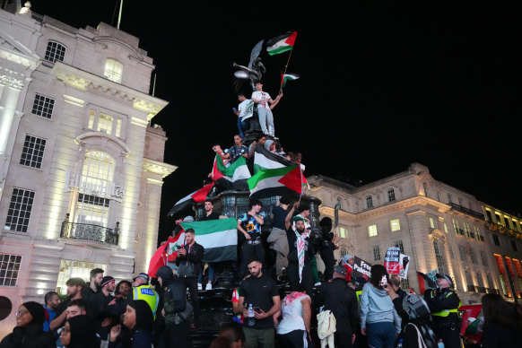 People take part in a demonstration in support of Palestine at Piccadilly Circus.