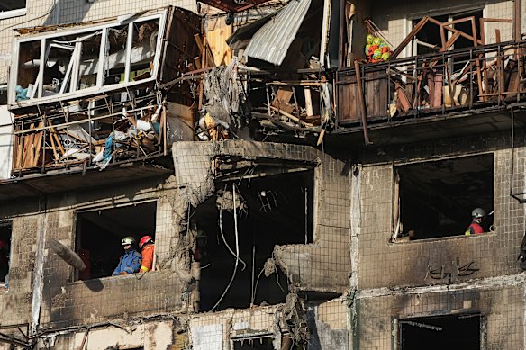 Rescuers at a building damaged in a Russian attack in Kyiv, Ukraine, on Friday.