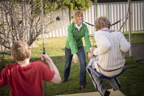 Briana Blackett plays with her two sons, who have autism, in their backyard.