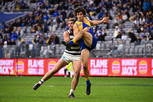 Tom Barrass, right, is bumped on a kick by Tom Hawkins. 