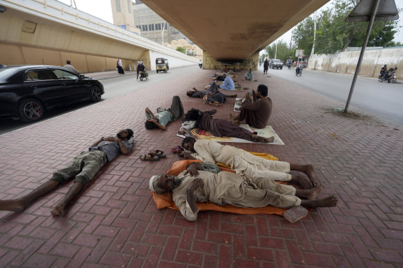 Labourers sleep under a bridge on a hot day in Karachi, Pakistan in July.