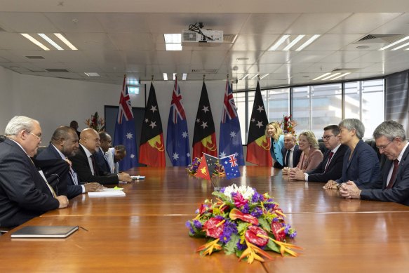 The large delegation of senior government officials at a meeting in PNG.