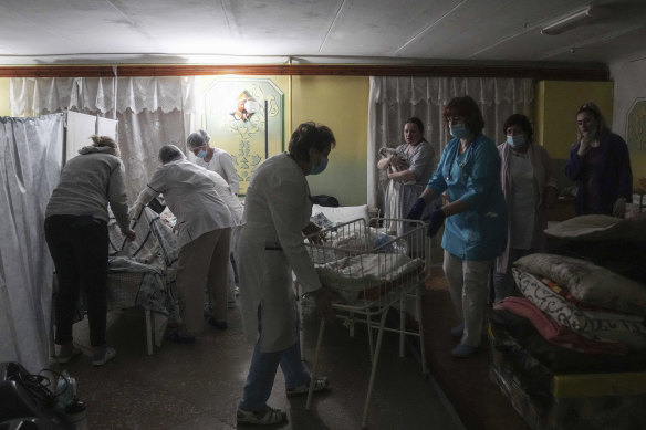 Medical workers tend to women who gave birth in a basement of a maternity hospital converted into a medical ward and used as a bomb shelter in Mariupol, Ukraine, on Tuesday.