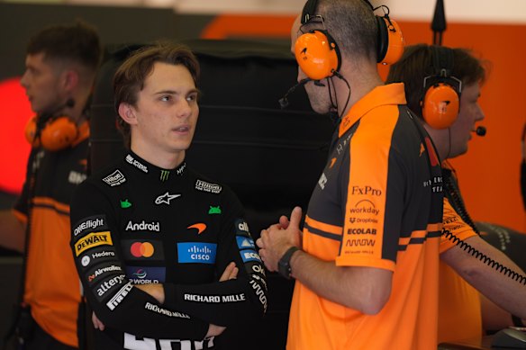 Oscar Piastri deep in discussions with a member of his team in Bahrain.