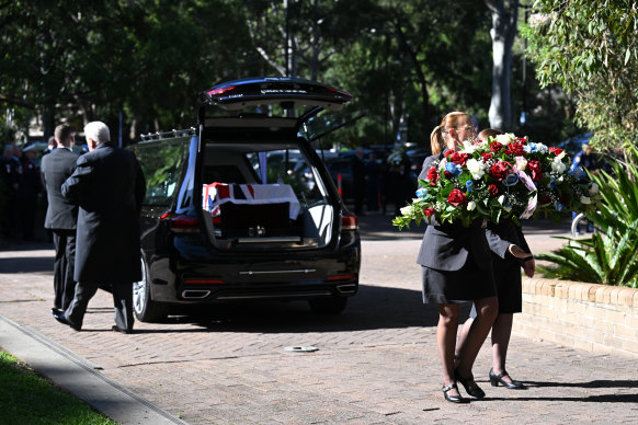 The casket of paramedic Steven Tougher arrives in a hearse at his memorial in Wollongong on Monday.