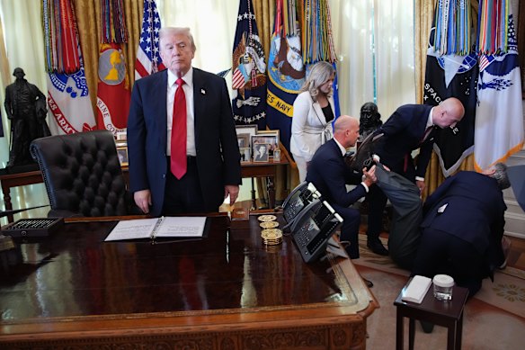A photo of Donald Trump appearing to ignore the plight of a man who collapsed has caught plenty of attention.