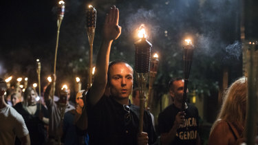A participant gives a Nazi salute during a march through the grounds of the University of Virginia in Charlottesville, Virginia in August 2017. 