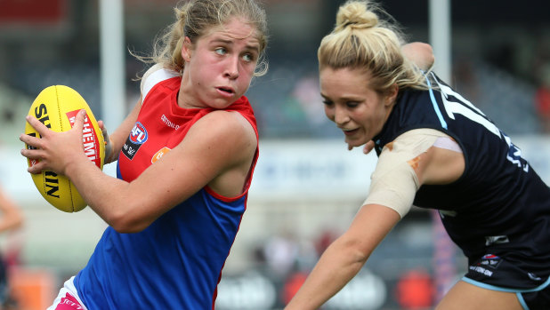 Cutting a dash: Melbourne's Katherine Smith shrugs off a tackle from Carltons's Jess Hosking.