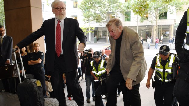 Robert Richter, QC, and Cardinal George Pell arrive at the Melbourne Magistrates Court on Thursday.