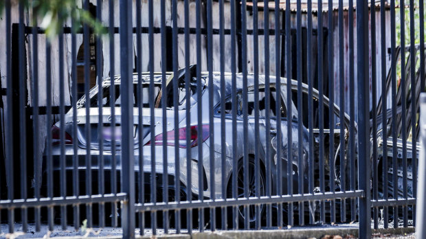 The burnt-out car found close to the shooting scene. 