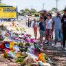 Mourners visit the makeshift memorial site at Hillcrest Primary School in 2021.