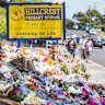 Mourners visit the makeshift memorial site at Hillcrest Primary School.