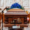 John Laws’ coffin at St Andrew’s Cathedral, flanked by his golden microphones.