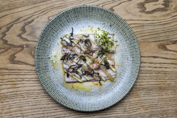 Smoked eel is plated as a perfect square and topped with apple and pickled kohlrabi.