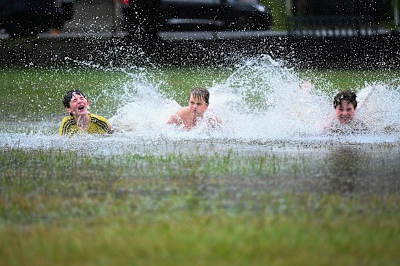 Young boys make the most of a flooded park in Rosalie.