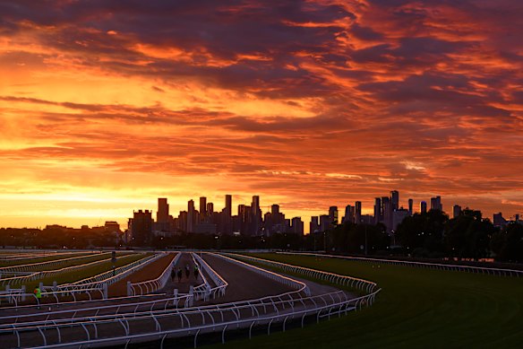 The sunrise is seen over the Melbourne skyline during gallops ahead of the Cox Plate, at Flemington Racecourse in Melbourne, Australia.
