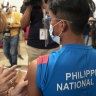 An athlete is inoculated with China’s Sinovac COVID-19 vaccine at a hotel turned into a temporary vaccination centre on Friday in Manila.