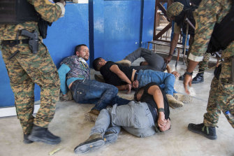 Suspects in the assassination of Haiti’s President Jovenel Moise are tossed on the floor after being detained, at the General Direction of the police in Port-au-Prince, Haiti, Thursday, July 8, 2021.