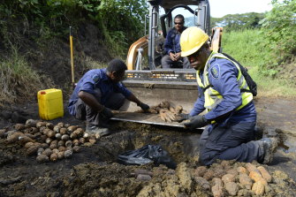A Solomon Islands police explosive ordnance disposal (EOD) team prepare to detonate artillery rounds, hand grenades and other munitions during clearance operations in 2018.
