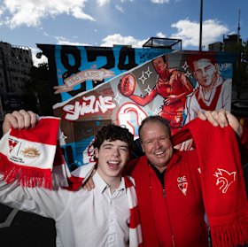 Rob and Charlie Pascoe at the Swans mural at South Melbourne market.