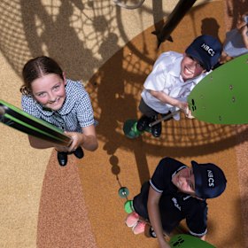 Students of Northern Beaches Christian School play on new playground equipment.