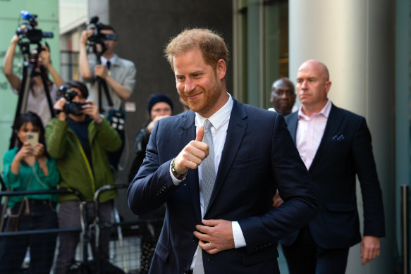 Prince Harry gives a thumbs up as he leaves after giving evidence in a separate trial involving the Mirror Group at London’s High Court in June.