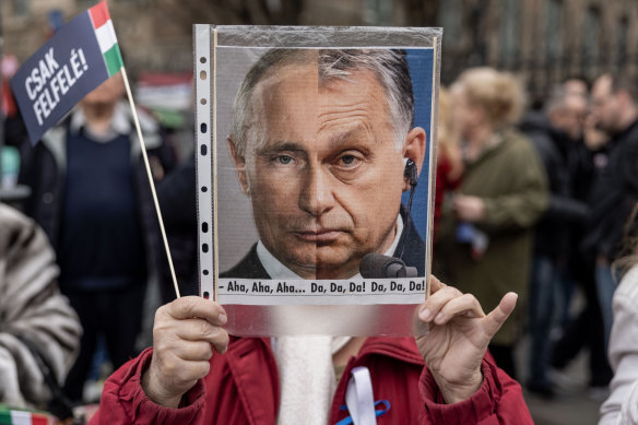 Supporter of the Hungarian Peter Marki-Zay hold and anti-Orban placard during a demonstration in Budapest, Hungary. 