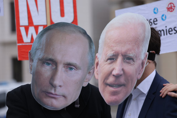 Protesters wear masks of Russian leader Vladimir Putin and US President Joe Biden at a rally in Berlin held to demand a diplomatic solution to the Ukraine crisis.