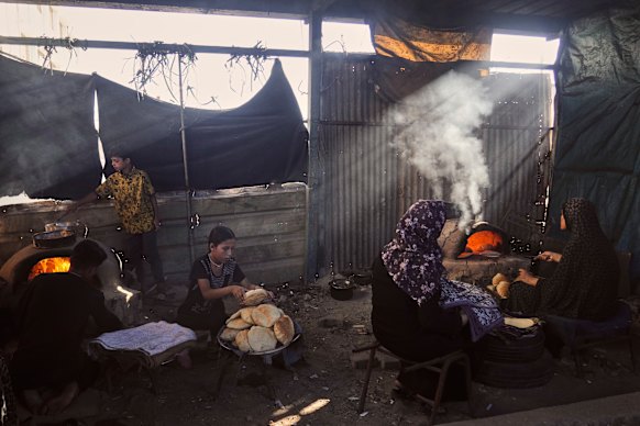 Displaced Palestinians bake bread in a school now serving as a shelter in Deir al-Balah, Gaza.